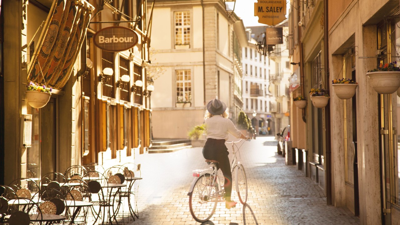 Someone cycling through a narrow alley in the old town centre.